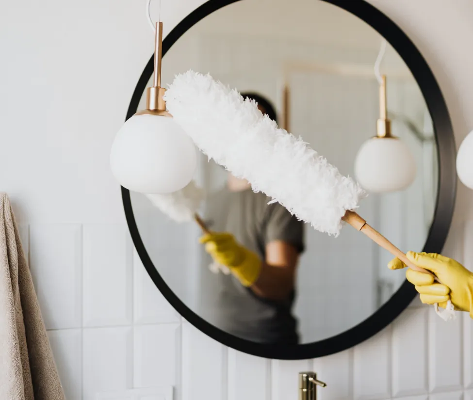 a person holding a white feather duster